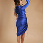 Woman modeling ruched royal blue satin dress with long sleeves on beige background