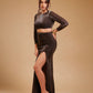 Woman modeling metallic brown crop top and high-slit skirt in studio fashion photoshoot