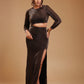 Woman in a metallic brown long sleeve cutout crop top and high slit skirt set posing indoors